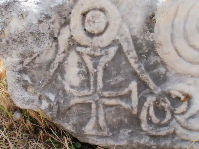 Cross with a circle on top engraved on a marble stone